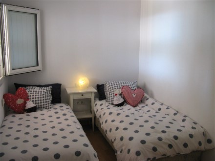 This bedroom has two single beds