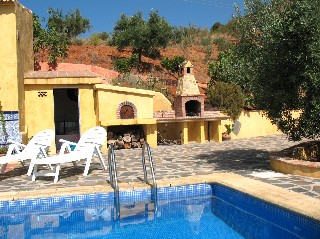 Neben dem Pool gibt es eine gemauerte Grillecke