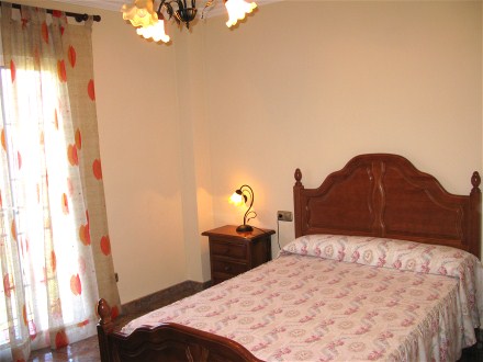 Das helle Schlafzimmer hat ein Doppelbett